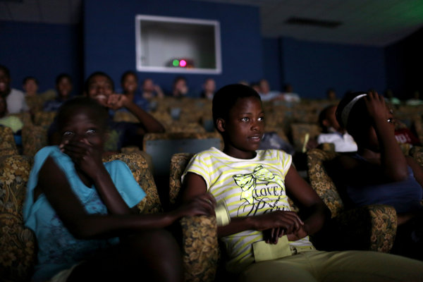 Residents of Kwamashu watching “Joe Bullet” this month. The film, released in 1972, was banned after only two showings. Credit Joao Silva/The New York Times